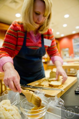 Laurel Mackenzie uses a brush to add a liquor mixture to a zuccotto during a cooking class at the Salud Cooking School at Harry's Farmers Market in Roswell on Thursday, January 23, 2014. 