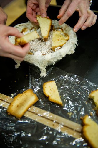 Students place pieces of pound cake in a bowl as they make a zuccotto during a cooking class at the Salud Cooking School at Harry's Farmers Market in Roswell on Thursday, January 23, 2014.