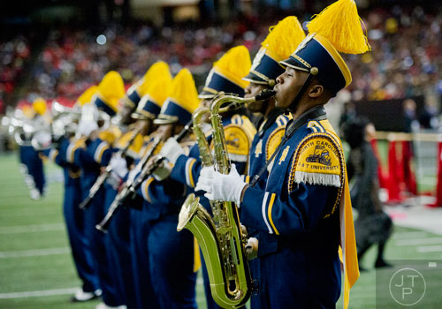 North Carolina A&T State University's Michael Bradford-Calhoun (right) plays the saxophone as he marches on the field during the 2014 Honda Battle of the Bands at the Georgia Dome in Atlanta on Saturday, January 25, 2014.