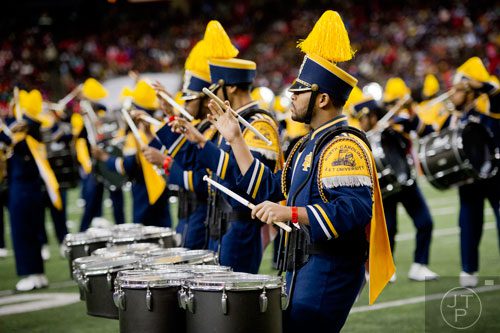 North Carolina A&T State University's Denard Smith twirls his drumstick as he plays the quads during the 2014 Honda Battle of the Bands at the Georgia Dome in Atlanta on Saturday, January 25, 2014. 