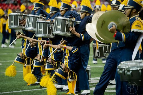 North Carolina A&T State University's Trey Caldwell (center top) holds Alan Siggers upside down as he plays the snare drum during the 2014 Honda Battle of the Bands at the Georgia Dome in Atlanta on Saturday, January 25, 2014. 