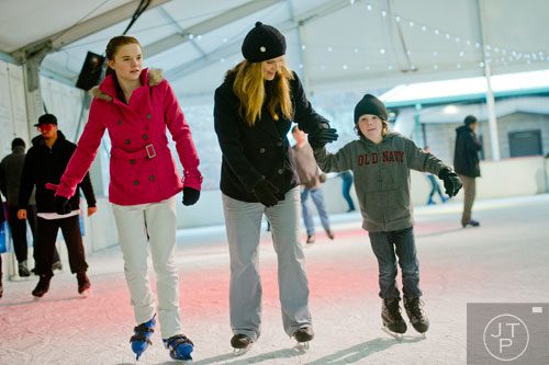 Shana Coover (center) ice skates with her daughter Jillian (left) and son Josiah  at Centennial Olympic Park in downtown Atlanta on Sunday, December 8, 2013.   