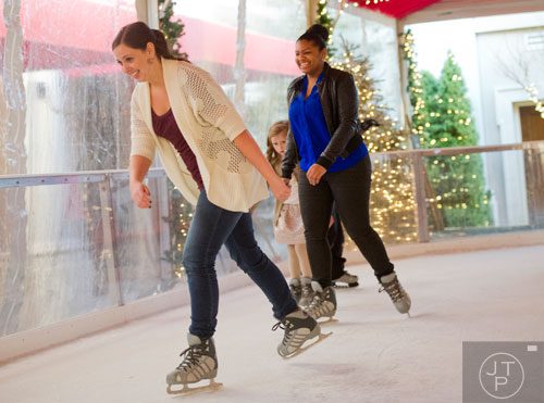 Lindsay Meckler (left) and Anila Singh ice skate at the St. Regis in Buckhead on Wednesday, December 18, 2013. 
