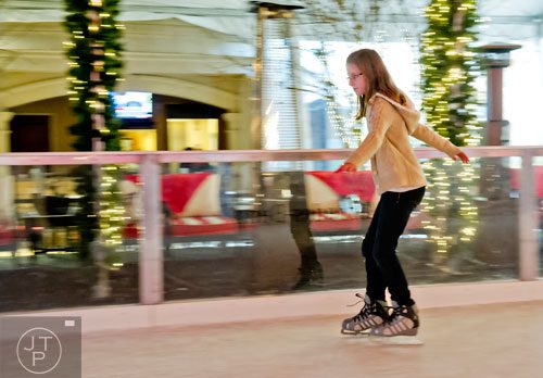 Anna Cochran flies around the rink as she ice skates at the St. Regis in Buckhead on Wednesday, December 18, 2013. 
