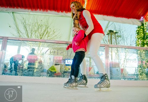Kiel Culpepper (left) learns to ice skate with the help of her mother Tricia Kinney at the St. Regis in Buckhead on Wednesday, December 18, 2013. 