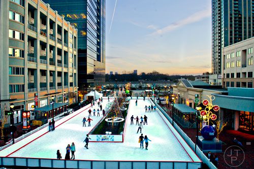 Visitors to Atlantic Station in Midtown ice skate at the open air rink on Thursday, December 19, 2013. 