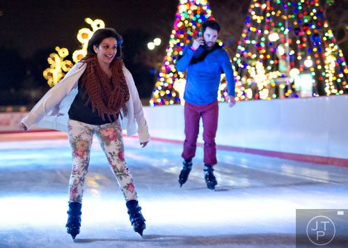 Almeera Jiwa Pratt (left) and J.C. Hamill ice skate at Atlantic Station in Midtown on Thursday, December 19, 2013. 