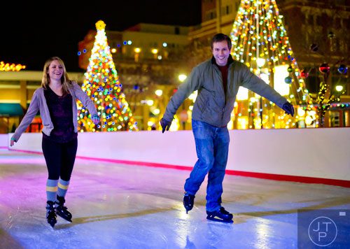 Lizzie Morgan (left) ice skates with her husband Adam at Atlantic Station in Midtown on Thursday, December 19, 2013. 