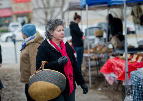 Bambi Arnold peruses the booths at the Decatur Farmers Market on Saturday, January 4, 2014. 