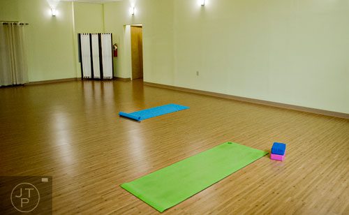 Yoga mats sit on the floor inside the studio at Breathe Yoga in Chamblee on Monday, January 6, 2014.