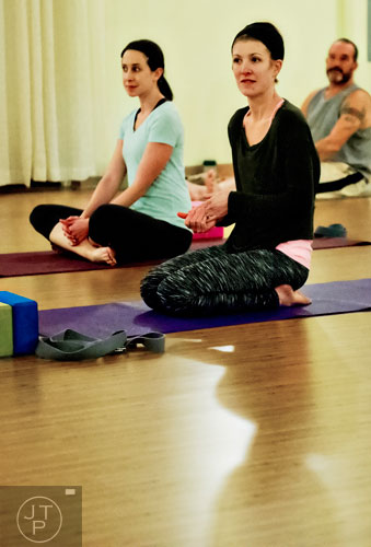 Melissa Dillon (center), Jackie Golden and Greg Isabel prepare for yoga class at Breathe Yoga in Chamblee on Monday, January 6, 2014. 