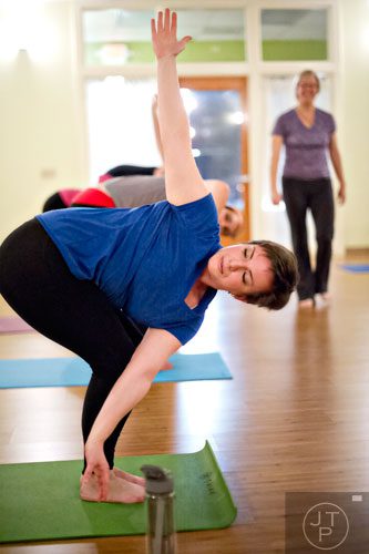Amanda Lawrence stretches into a pose during yoga class at Breathe Yoga in Chamblee on Monday, January 6, 2014. 