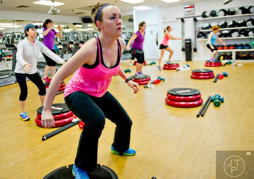 Julie Orr (left) works out during a Blast 900 class in Dunwoody on Friday, January 10, 2014. 