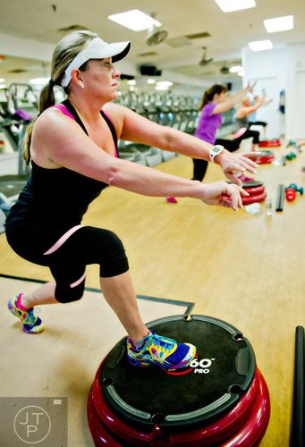 Paige Huff (left) works out during a Blast 900 class in Dunwoody on Friday, January 10, 2014. 
