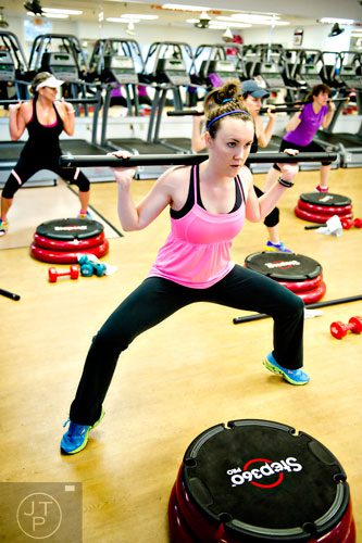 Julie Orr (center) lifts weights during a Blast 900 class in Dunwoody on Friday, January 10, 2014. 