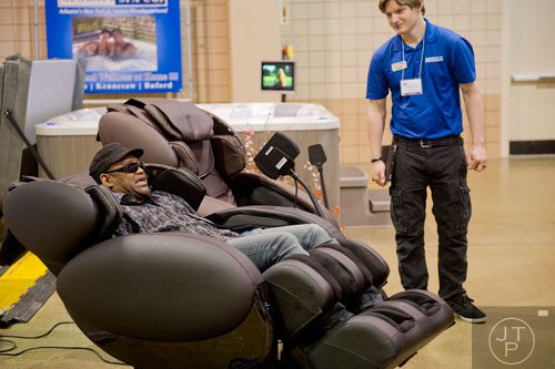 Juaderro Dowd (left) sits in a massaging chair as he talks over options with David Campbell at the North Atlanta Home Show at the Gwinnett Center in Duluth on Sunday, February 23, 2014. 