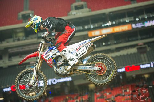 Justin Starling (99) catches some air as he competes in a qualifying round of the Monster Energy AMA Supercross FMI World Championship at the Georgia Dome in Atlanta on Saturday, February 22, 2014.  