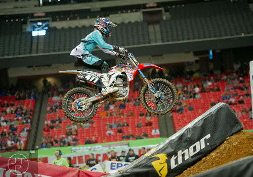 Logan Karnow (471) catches some air as he competes in a qualifying round of the Monster Energy AMA Supercross FMI World Championship at the Georgia Dome in Atlanta on Saturday, February 22, 2014. 