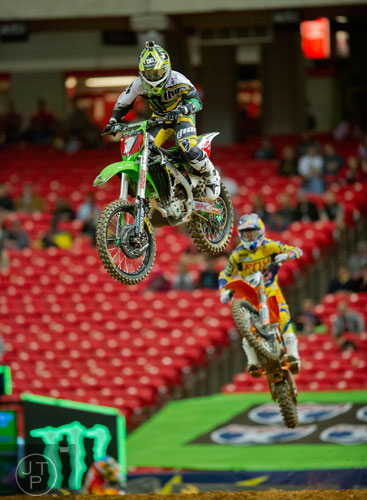 Ryan Villopoto (1) catches some air as he competes in a qualifying round of the Monster Energy AMA Supercross FMI World Championship at the Georgia Dome in Atlanta on Saturday, February 22, 2014.