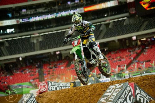 Ryan Villopoto (1) catches some air as he competes in a qualifying round of the Monster Energy AMA Supercross FMI World Championship at the Georgia Dome in Atlanta on Saturday, February 22, 2014. 