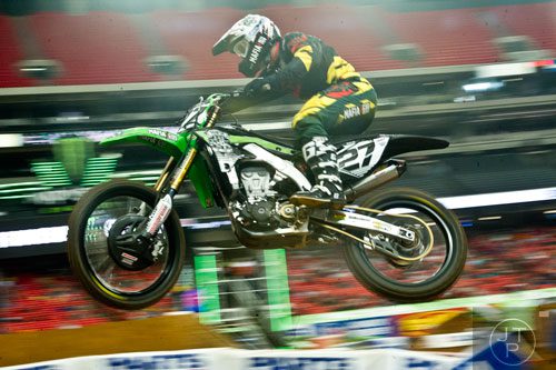 Nicholas Wey (27) catches some air as he competes in a qualifying round of the Monster Energy AMA Supercross FMI World Championship at the Georgia Dome in Atlanta on Saturday, February 22, 2014.