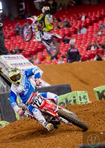 Adam Enticknap (722) takes a turn as he competes in a qualifying round of the Monster Energy AMA Supercross FMI World Championship at the Georgia Dome in Atlanta on Saturday, February 22, 2014. 
