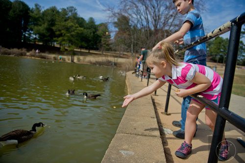 Elaina Vowell (right) and her brother Alex feed the geese at Shorty Howell Park in Duluth on Sunday, February 23, 2014. 