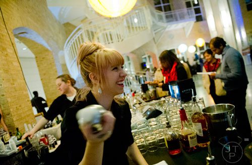 Katie Drake (center) makes martinis as she bartends during Martinis & IMAX at the Fernbank Museum of Natural History in Atlanta on Friday, January 31, 2014.