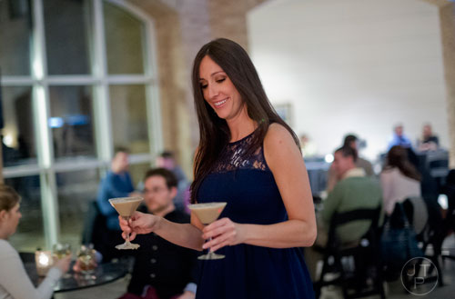 Laurie Wiley carries martinis back to her table during Martinis & IMAX at the Fernbank Museum of Natural History in Atlanta on Friday, January 31, 2014. 