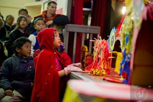 Amalia Fox (left) watches the performances during the Atlanta Chinese Lunar New Year Festival in Chamblee on Saturday, February 1, 2014.