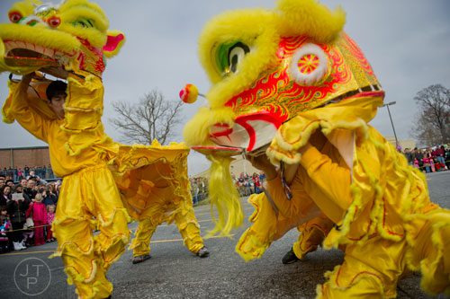 Chris Lu (left) and Dominique Maharath perform as Fu dogs during the Atlanta Chinese Lunar New Year Festival in Chamblee on Saturday, February 1, 2014. 