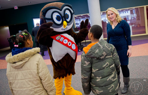 Chrissy Warrilow (right) and Owlie, the NOAA mascot, talk with children during the kickoff for the American Meteorological Society's 94th annual meeting at the Atlanta-Fulton Public Library in downtown on Saturday, February 1, 2014. 