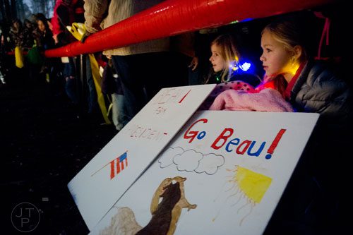Charley Lacey (right) and Vivian Lane hold signs as they and a few hundred people wait for General Beauregard Lee to appear at the Yellow River Game Ranch in Lilburn on Sunday, February 2, 2014. 