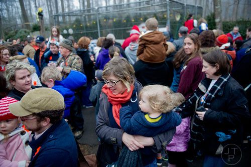 Angela Nichols (center) carries her son Grey as the crowd of a few hundred disperses from in front of General Beauregard Lee's enclosure at the Yellow River Game Ranch in Lilburn on Sunday, February 2, 2014. 