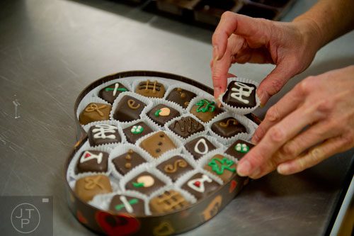 Linda Damiani fills a box with chocolate truffles at Chamberlain's Chocolate Factory in Peachtree Corners on Tuesday, February 4, 2014.