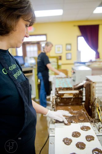 Anne Stroer (left) and Linda Damiani make turtles at Chamberlain's Chocolate Factory in Peachtree Corners on Tuesday, February 4, 2014. 