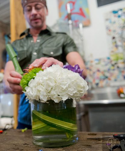 John McDonald arranges a vase of flowers at Twelve in the Virginia Highlands neighborhood of Atlanta on Tuesday, February 4, 2014.   