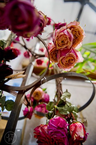 Dried roses hang from a stand at Twelve in the Virginia Highlands neighborhood of Atlanta on Tuesday, February 4, 2014.