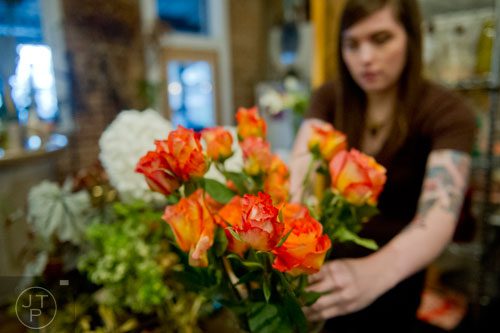 Louise Elliott trims and arranges a bunch of roses at Twelve in the Virginia Highlands neighborhood of Atlanta on Tuesday, February 4, 2014. 