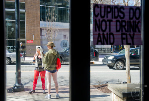 Allison Alford (left) talks to Nate Ohs outside Ri Ra Irish Pub before the start of the Cupid Undies Run in Midtown on Saturday, February 15, 2014. 