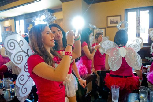 Alaina Daner (left) takes photos at Ri Ra Irish Pub before the start of the Cupid Undies Run in Midtown  as her mother Maria watches on Saturday, February 15, 2014. 
