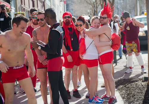 Damon Jolley (right) hugs Lindsay Baker as they try to stay warm before the start of the Cupid Undies Run in Midtown on Saturday, February 15, 2014. 
