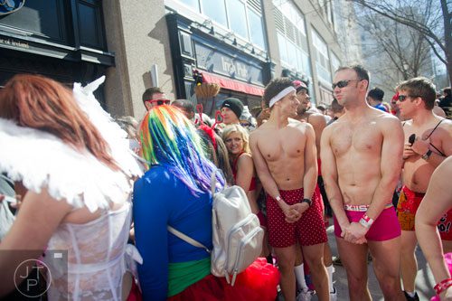 John Saindon (right) and Brian Phipps try to stay warm before the start of the Cupid Undies Run in Midtown on Saturday, February 15, 2014. 