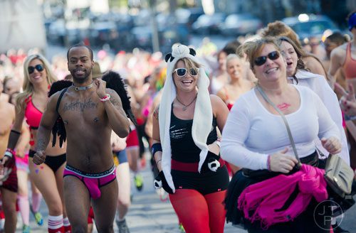 Brian Green (left) and Allison Alford run up 12th St. during the Cupid Undies Run in Midtown on Saturday, February 15, 2014. 