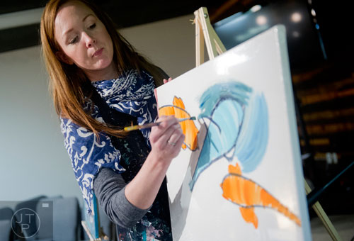 Kate Saville Hawkins (left) explains the next step to painting sharks and coy fish during Mother-Son Date Night at Saville Studios in Peachtree City on Saturday, February 15, 2014. 