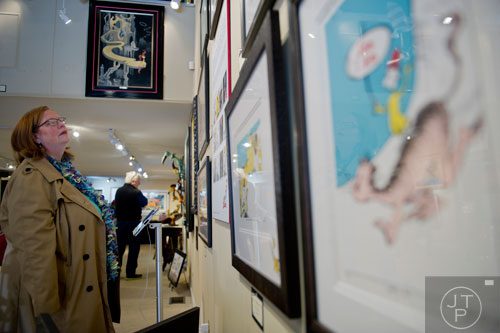 Bonnie Icaro looks at artwork on display for the "Hats Off to Dr. Seuss" national traveling exhibit at the Ann Jackson Gallery in Roswell on Sunday, February 16, 2014. 