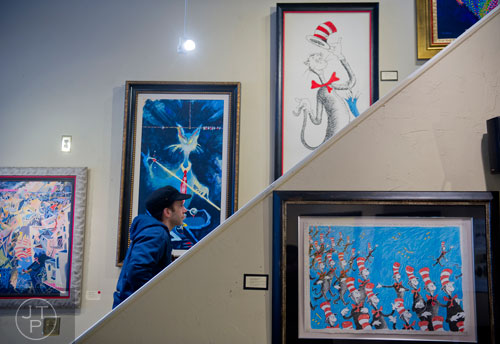 Keith Izen looks at artwork on display for the "Hats Off to Dr. Seuss" national traveling exhibit at the Ann Jackson Gallery in Roswell on Sunday, February 16, 2014. 