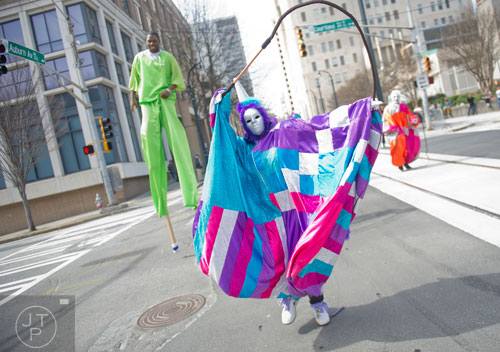 Monique Lloyd (center) cracks her whip as she makes her way down Auburn Ave. in Atlanta during the Black History Month Parade on Saturday, February 22, 2014. 