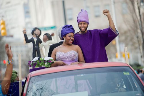 Robin Roberson (left) and her husband Raymond wave to the crowd as they make their way down Auburn Ave. in Atlanta during the Black History Month Parade on Saturday, February 22, 2014. 