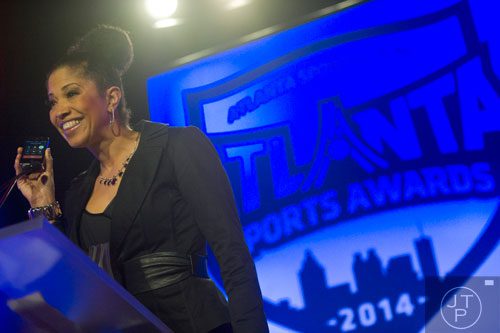 Tisha DeShields holds up the phone so her daughter Diamond DeShields can accept the award for High School Athlete of the Year during the 9th annual Atlanta Sports Awards at the Fox Theatre on Wednesday, March 5, 2014. 